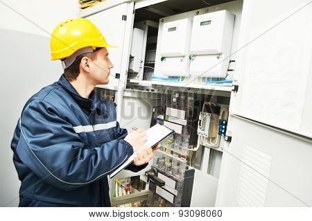 electrician builder engineer inspector checking data of equipment in fuse box