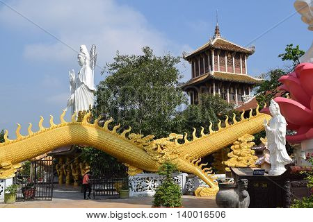 Binh Duong Vietnam June 16 2016: big statue of Bodhisattva and golden dragon at Buddhist Chau Thoi temple