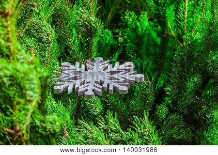 Christmas decoration. Large silver decorative snowflake pine branches.