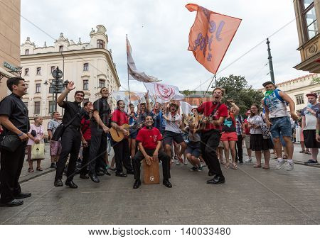 CRACOW POLAND - JULY 24 2016: Pilgrims of World Youth Day sing and dance on the Main Square in Cracow. Poland
