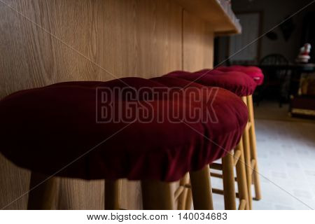 Row of Bar Stools with Red Padded Cushioned Seats