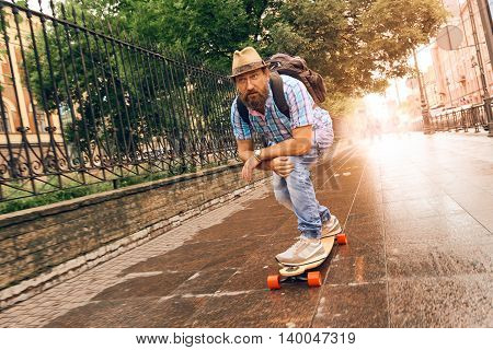 Man riding on longboard in the streets urban, setting of lifestyle concept