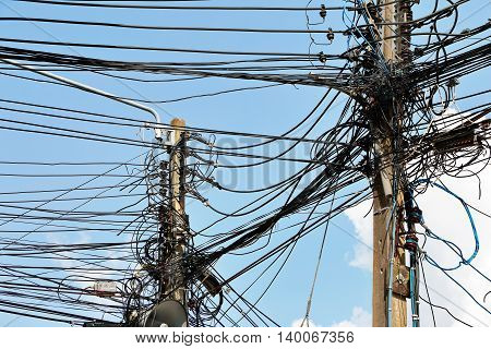 Electronic and cable line in city chaotic wire on pole with sky background