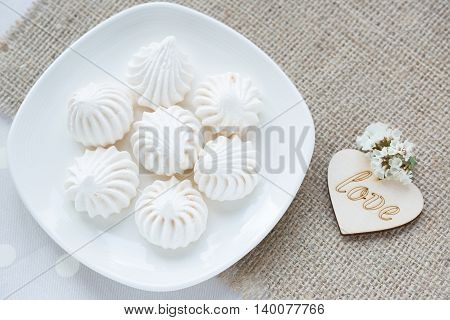 Meringue - the Traditional French dessert on a light background close up the top view