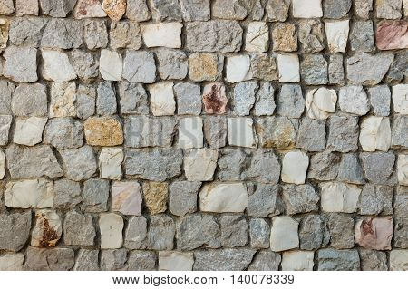 closeup of stone wall with grey and white stones