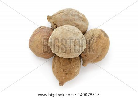 Organic dry Bahera or Beleric (Terminalia bellirica) seeds. Isolated on white background. Macro close up. Top view.