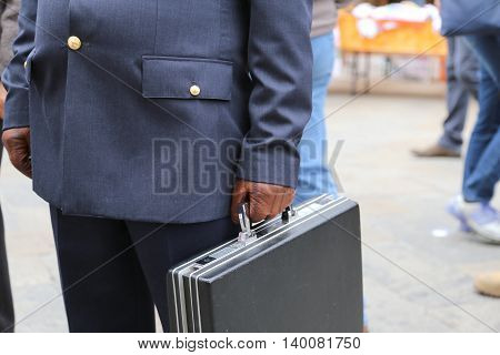 Cop With A Suitcase With Many Documents