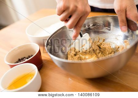 Woman mixing the dough for making cookies