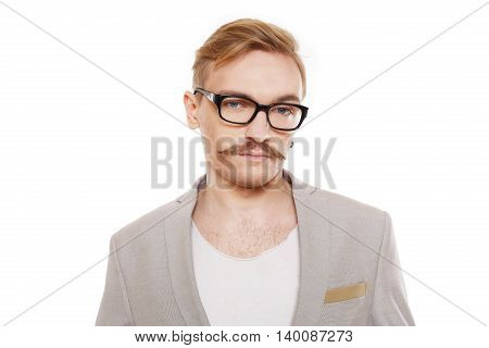 Young stylish blond man in beige blazer isolated at white. Portrait of confident guy looking at camera. Boy style, trendy male person in eyeglasses and black suit. Modern businessman.