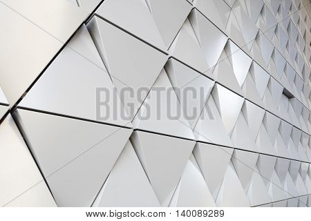 Abstract photo close-up view of modern aluminum ventilated facade of triangles