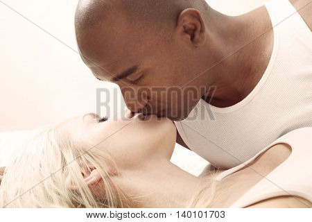 Black man and white woman kissing each other
