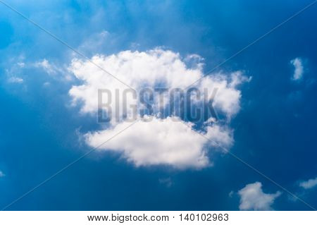 White cloud in the blue sky .