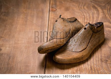 Shoe Lasts on the wooden background. Retro style