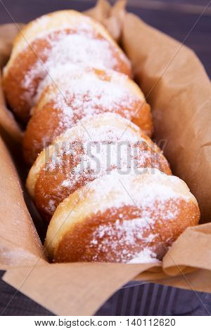 German donuts - delicious berliner with jam and icing sugar in a box