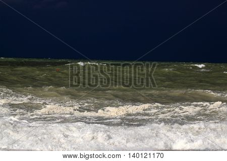 Stormy sea with waves und a dark blue sky.