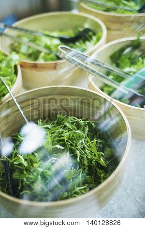 bowls of green lettuce and mixed salad keaves