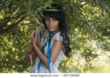 the girl with a small rabbit in his hands