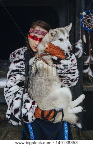 american indian girl with makeup in winter with a dog