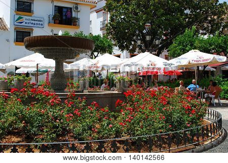 ESTEPONA, SPAIN - JULY 18, 2008 - People relaxing at pavement cafes in the Plaza las Flores Estepona Malaga Province Andalucia Spain Western Europe, July 18, 2008.