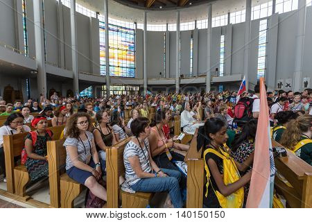 CRACOW POLAND - JULY 26 2016: World Youth Day 2016 - Crowd of Pilgrims inside of the Sanctuary of Divine Mercy in Lagiewniki. Cracow Poland