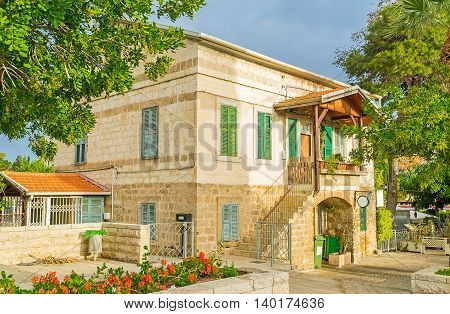 The typic house of the German Colony surrounded by trees and flower beds Haifa Israel.