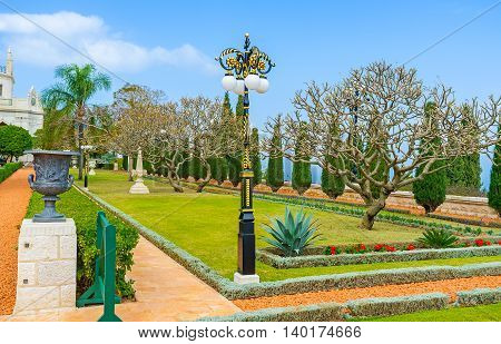 The Bahai Garden boasts beautiful park sculptures and old style streetlights along the alleys Haifa Israel.