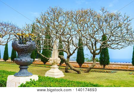 The vase with gilt metal flowers in Bahai Gardens Haifa Israel.