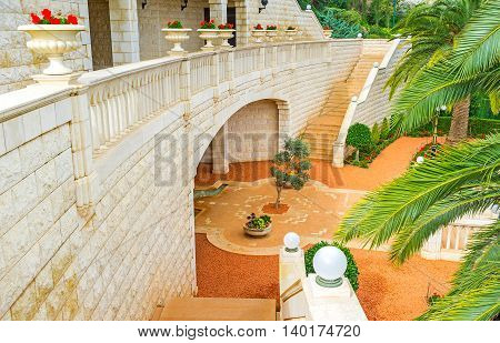 The terraces of Bahai Gardens separated with the stone constructions including the wall staircases viewpoint and decorative elements Haifa Israel.