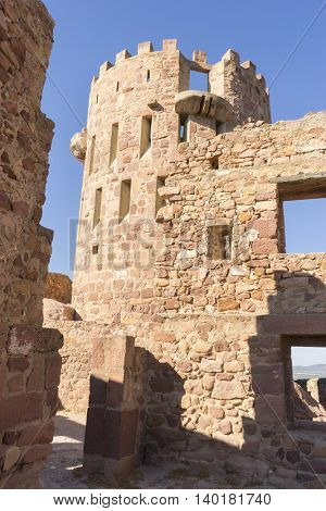 castle with battlements and walls of red stones, Villafames rural villa in Castellon, Valencia region in Spain