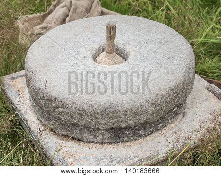 The ancient stone hand mill with grain and bag