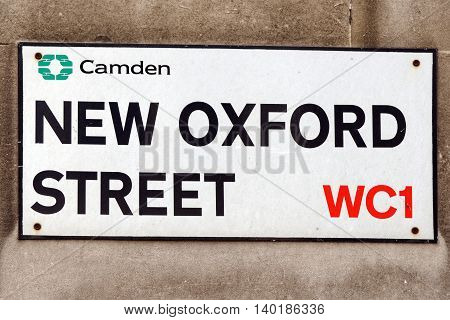 A sign on a street wall for New Oxford Street in Central London