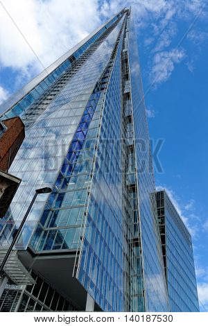 LONDON UK - JULY 1 2014: The Shard skyscraper designed by the Italian architect Renzo Piano has 87 storeys over a height of 1004 feet. The Shard is the tallest building in Europe.