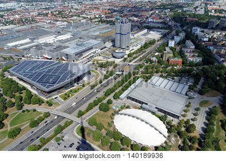 MUNICH GERMANY - AUGUST 4 2015: Aerial view of Munich with part of the Olympic Park the BMW Museum and headquarters from the 291 m high Olympic tower (Olympiaturm).
