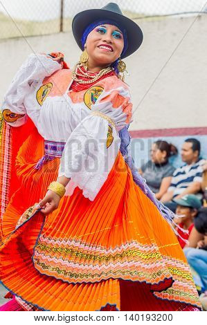 Banos De Agua Santa Ecuador - November 29 2014: Unidentified Youth Indigenous Woman Dancing On City Streets Of Banos De Agua Santa South America