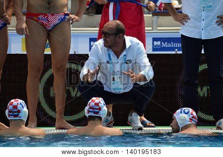 Budapest Hungary - Jul 14 2014. Ivica Tucak (head coach) talking to the croatian team. The Waterpolo European Championship was held in Alfred Hajos Swimming Centre in 2014.