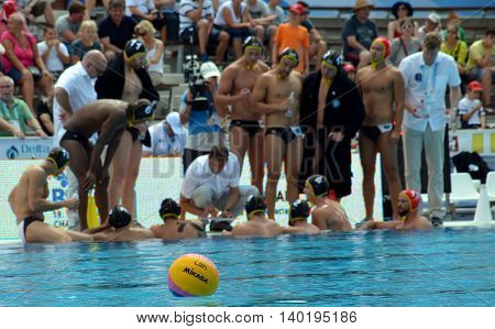 Budapest Hungary - Jul 14 2014. Waterpolo ball in the focus the german waterpolo team in the background. The Waterpolo European Championship was held in Alfred Hajos Swimming Centre in 2014.