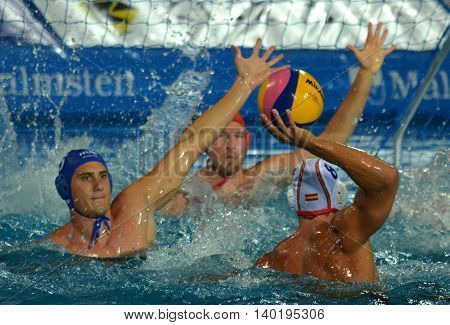 Budapest Hungary - Jul 14 2014. Albert ESPANOL LIFANTE (ESP 8) shooting. Marton Vamos (HUN 5) and Viktor Nagy (HUN 1) defend the hungarian team's goal. The Waterpolo European Championship was held in Alfred Hajos Swimming Centre in 2014.