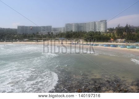 beautiful tropical beach with strong wave and building on the shore in muine vietnam
