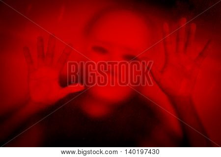 Woman wearing white mask behind stained or dirty window glass,Scary background for book cover