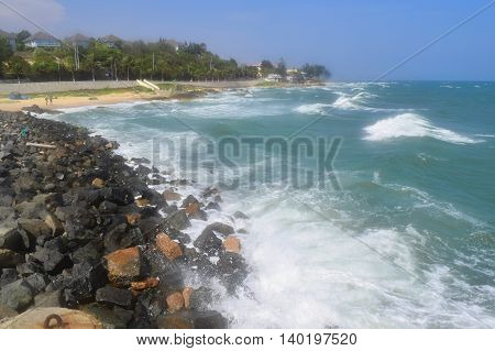 beautiful tropical beach with strong wave and building on the shore in muine vietnam