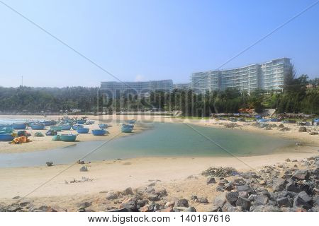 beautiful tropical beach with basket boats and building on the shore in muine vietnam