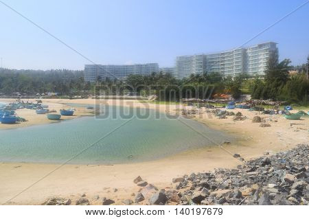 beautiful tropical beach with basket boats and building on the shore in muine vietnam