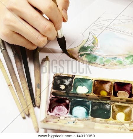 Hand with brush and paint