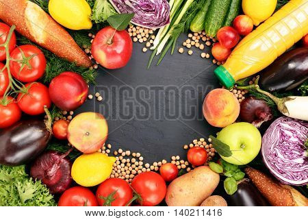 Frame of colorful fruits vegetables pasta and orange juice on dark surface. Frame of colorful fruits and vegetables background top view.