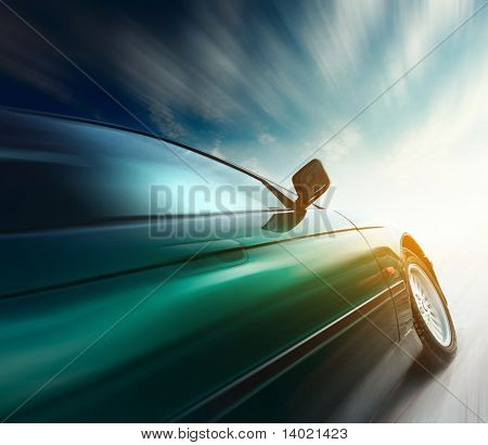 Blurred car on road and sky with clouds