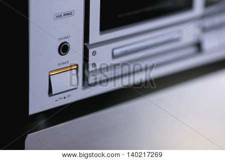 Vintage audio stereo rack with cassette tape deck receiver and speaker, angled view