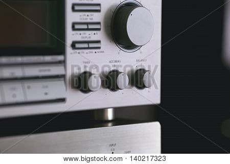 Vintage audio stereo rack with cassette tape deck receiver and speaker, angled view