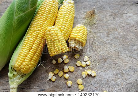 Close up fresh corns on wooden table.