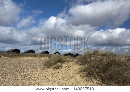 Beach Huts in amongst the sand dunes at Walberswick Suffolk England