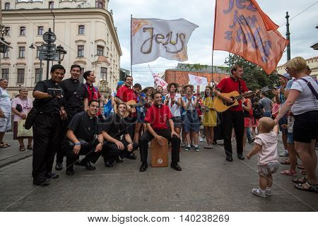 CRACOW POLAND - JULY 24 2016: Pilgrims of World Youth Day sing and dance on the Main Square in Cracow. Poland